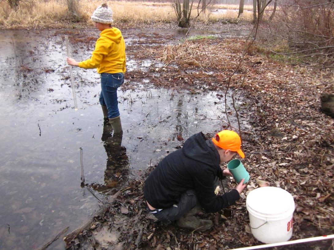 Students collecting water samples at Blackfork Wetlands